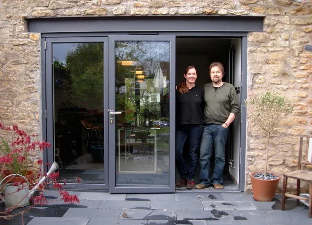 Happy customers with their new bifold doors