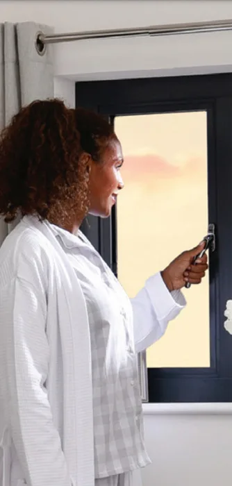 Lady looking out of Origin Aluminium window