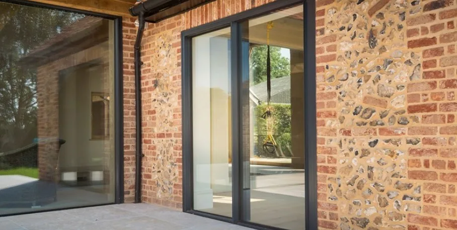 Origin OS-20 ultra-slim aluminium sliding door, open onto a terrace