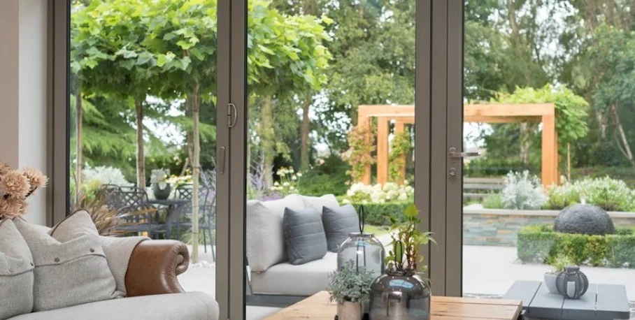 Origin OB-72 aluminium bi-fold door, open onto a patio