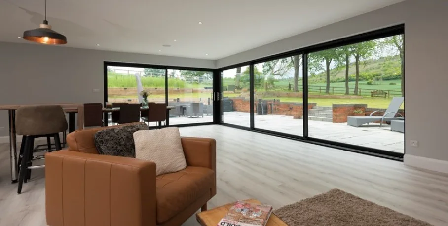 Origin OS-44 aluminium sliding door open onto a terrace