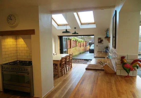 Kitchen diner with a range cooker, roof lights and bifold doors at the far end