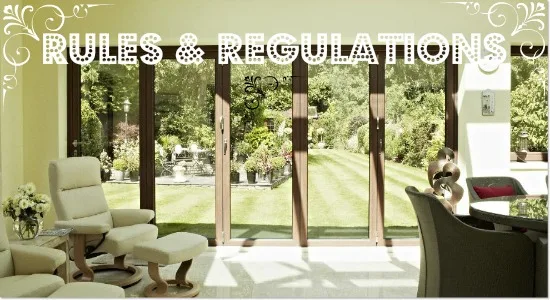 Timber bifold doors opening from a garden room onto a lawn