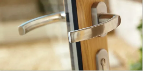Close-up of the stainless steel handles and lock on a timber bifold door