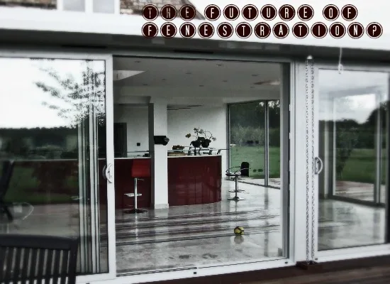 View through bifold doors into a kitchen with a red island unit