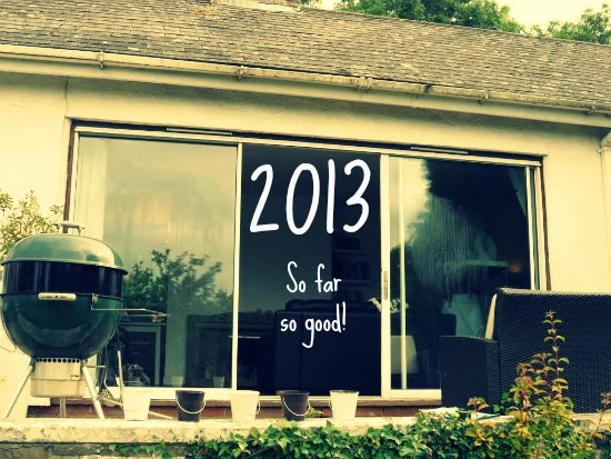 ‘2013 – so far so good’ written across patio doors beside a garden barbecue