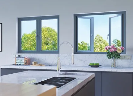 Two grey Origin aluminium casement windows above a kitchen worktop