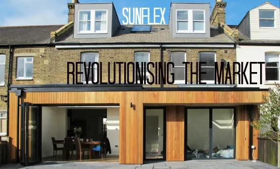 Sunflex doors in the timber-clad ground floor of a brick townhouse