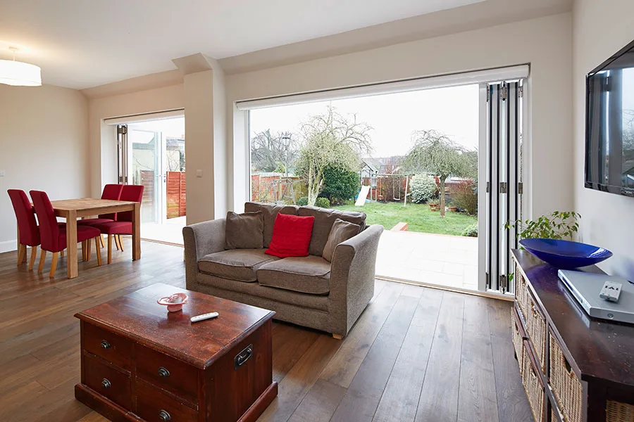 Aluminium bi-fold door with Origin frames, open onto a patio