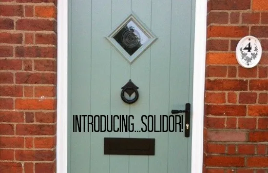 Sage green Solidor composite front door in a brick surround